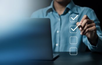 Business project approval concept,  businessman using a pen to mark the correct checkboxes.