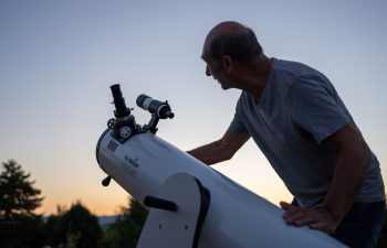 Saint Genis Laval, France - 9th of August 2024: A hobbyits astronomer looking through the telescope.