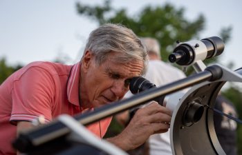 Saint Genis Laval, France - 9th of August 2024: A hobbyits astronomer looking through the telescope.